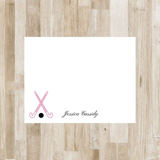 Personalized field hockey flat notecard with pink sticks, black ball and black script name