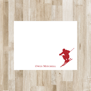 Personalized skier flat notecard with red skier and red name