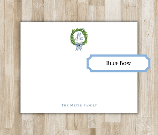 Personalized monogram wreath flat notecard with blue bow, blue script monogram and blue name
